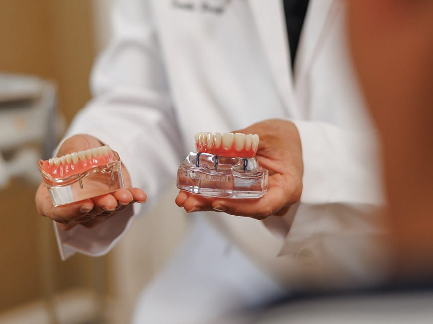 Traditional denture problems — slipping, bone loss, adhesive dependence